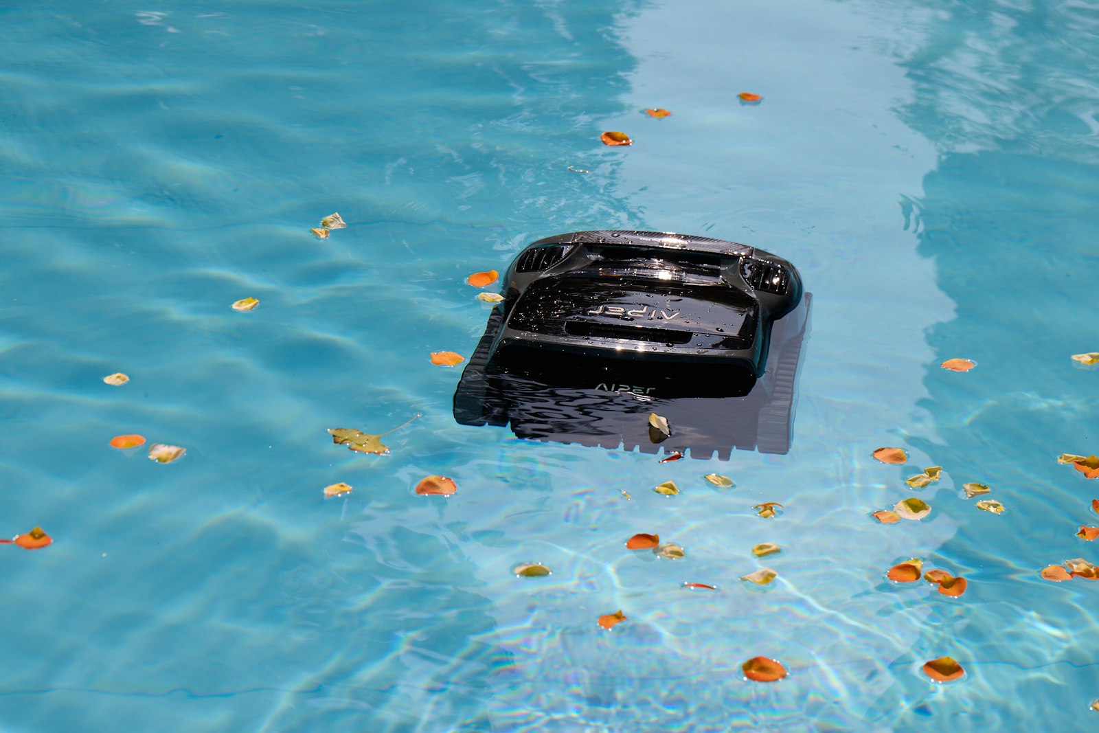 Pool Closing Service - Fairfield County CT 1 Pool closing service — automated cleaner removing fall leaves, Fairfield & Westchester